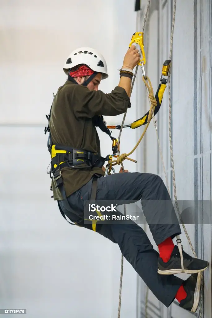 man is the climbs the wall